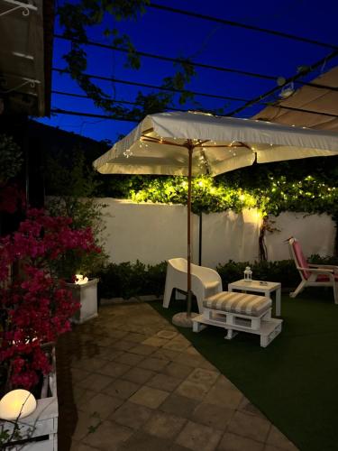 a patio with an umbrella and a table and chairs at Alemar Bed & Breakfast in Mondello