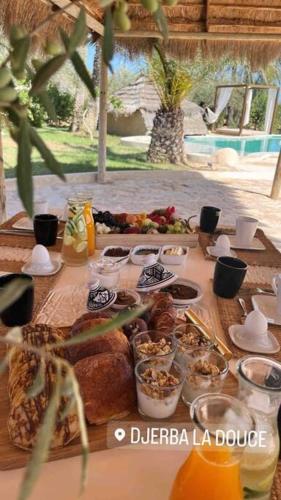 a table with food and drinks on top of it at Menzel Al karam, in Temlale