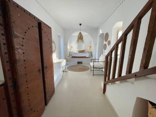 a hallway with a door and a room with a bed at Menzel Al karam, in Temlale