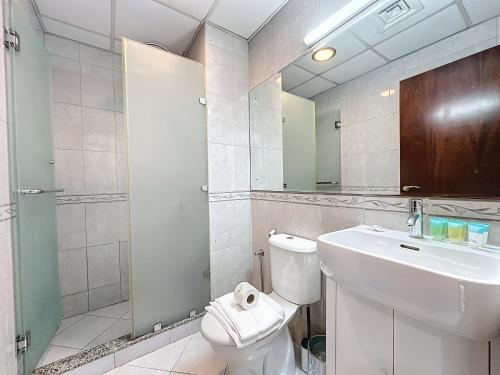 a bathroom with a toilet and a sink and a mirror at Key View - Marina Park in Dubai