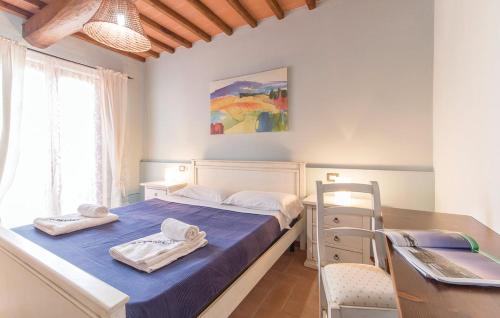 a bedroom with a bed and a desk and a table at Casa Macinarino 13 in Loro Ciuffenna