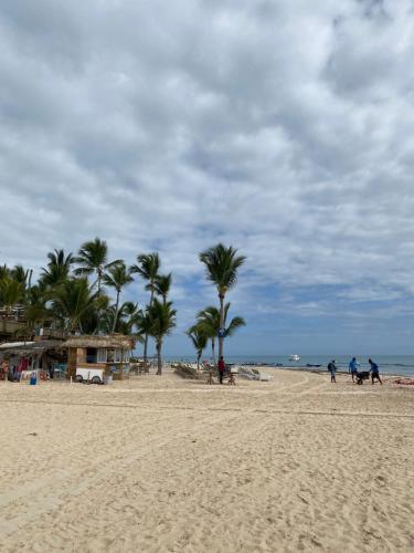 people riding horses on a beach with palm trees at paradise close to the beach pool free parking,wifi- punta cana in Punta Cana