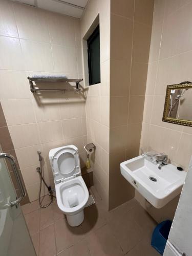 a bathroom with a toilet and a sink at FJ Haven in Penampang