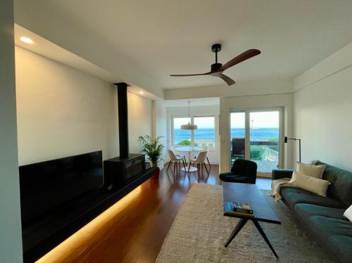 a living room with a couch and a flat screen tv at Oceanview 4 U - Close to Lisbon! in Oeiras