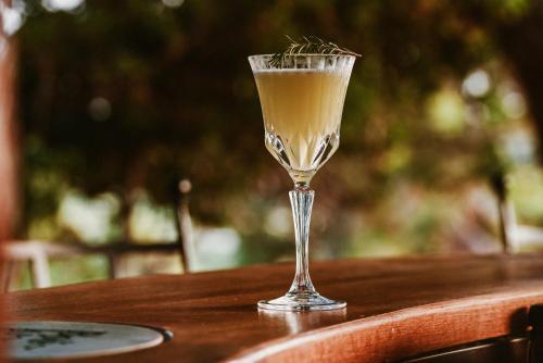 a drink in a glass sitting on a table at Boutique Hotel Boškinac in Novalja