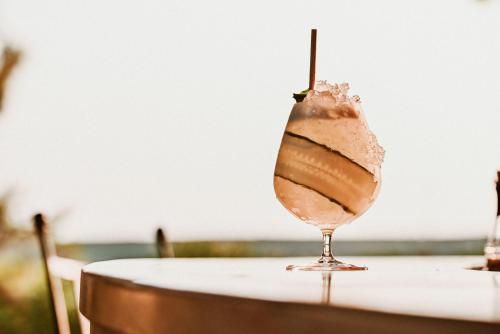a drink sitting on top of a table at Boutique Hotel Boškinac in Novalja