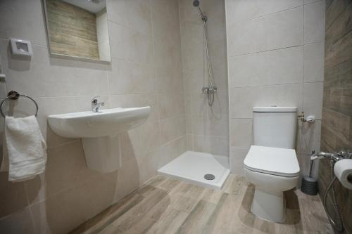 a bathroom with a toilet and a sink at Le gris Perle in Sfax