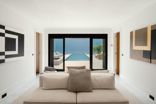 a living room with a couch and a view of the water at Villa MUSA in Lenno