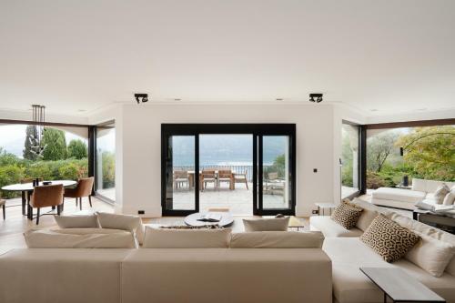 a living room with a large couch and a table at Villa MUSA in Lenno