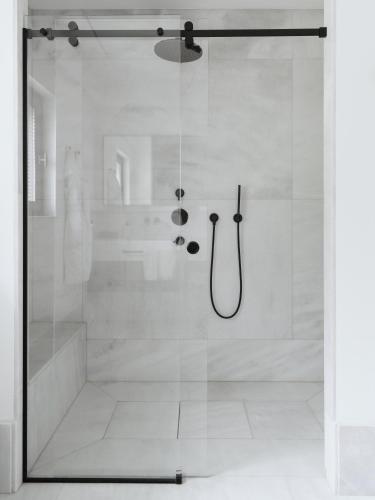 a shower with a glass door in a bathroom at Villa MUSA in Lenno