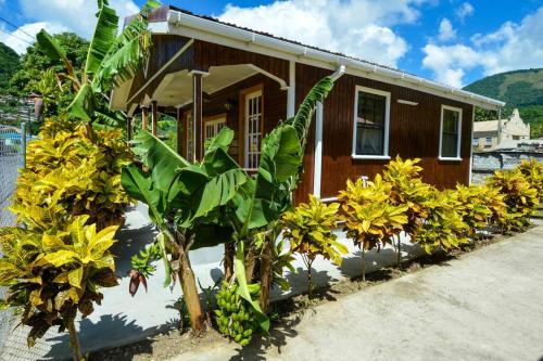a small house with plants in front of it at River Breeze Villa, 5 minutes to beach and town in Soufrière
