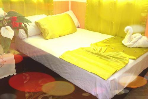 a bed with two swans sitting on top of it at River Breeze Villa, 5 minutes to beach and town in Soufrière