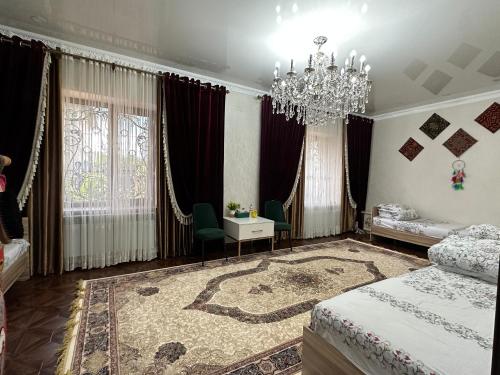 a bedroom with a bed and a chandelier at Sultan Saray in Osh