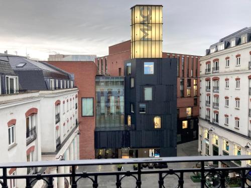 a tall black building in a city with buildings at Cathedral Quarter Apartments in Belfast