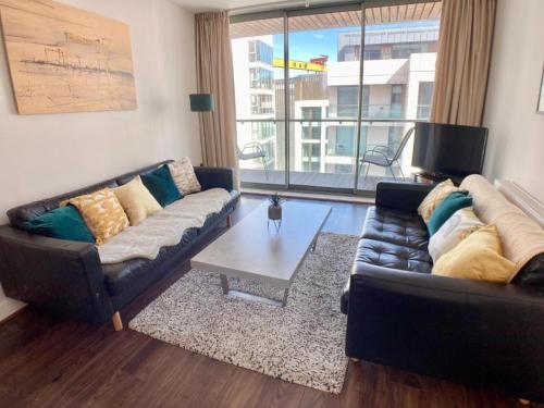 a living room with a couch and a coffee table at Hamilton Road Apartments in Belfast