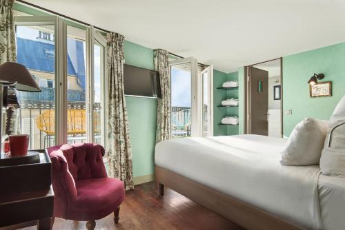 a bedroom with a bed and a chair and a window at R. Kipling by Happyculture in Paris