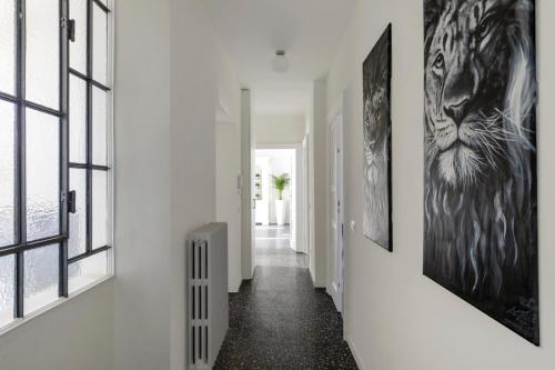 a hallway with black and white art on the walls at Residenza '900 in Castellanza