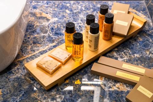 a wooden tray with four bottles of essential oils on it at FLOARA DI MUNTE Forest Luxury Suites in Metsovo