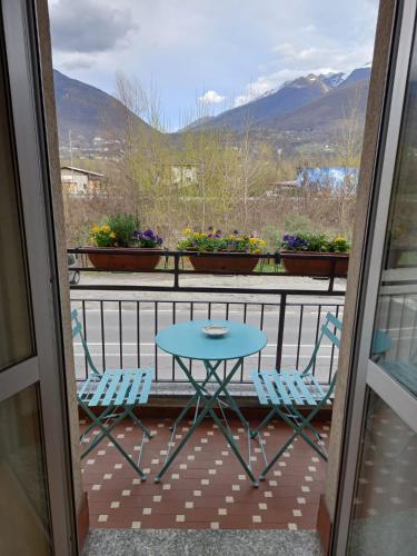 a table and chairs on a balcony with a view at Ossola Bella la tua casa in Domodossola