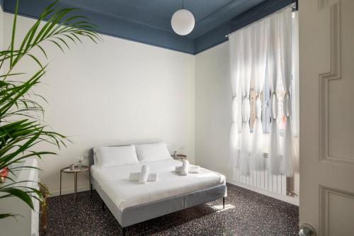 a bedroom with a white bed and a window at Residenza '900 in Castellanza