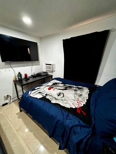 a bedroom with a bed with a tv on the wall at The Black Door miami in Miami