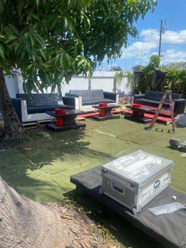 a grill sitting on a table under a tree at The Black Door miami in Miami