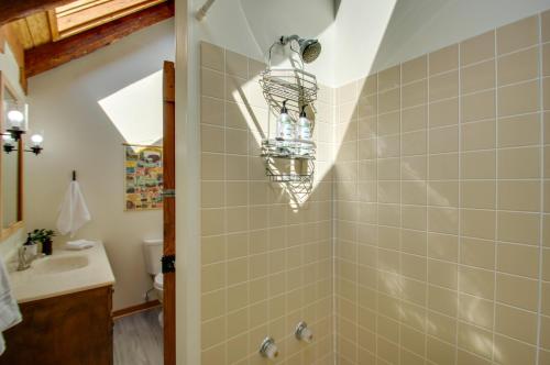 a bathroom with a shower and a sink at Cozy Log Cabin Getaway with Fire Pit and 3 Acres! in Ruckersville