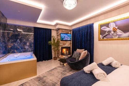 a hotel room with a tub and a bedroom at FLOARA DI MUNTE Forest Luxury Suites in Metsovo