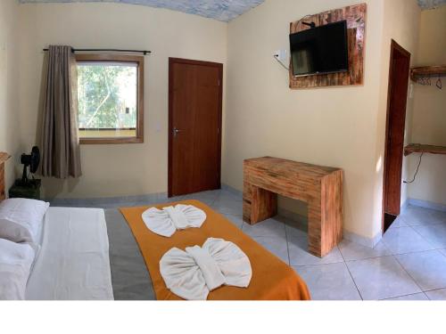 Een bed of bedden in een kamer bij Pousada Casinha Velha