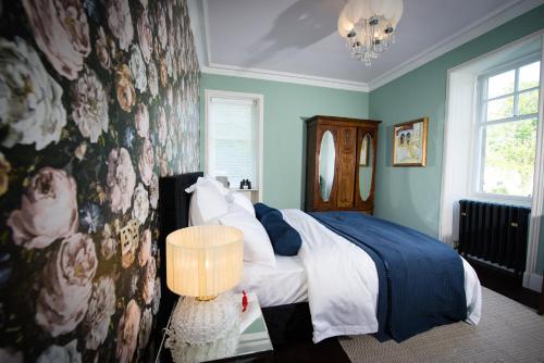a bedroom with a bed with blue walls at Ardrhu House Fort William - Superior Room in Fort William