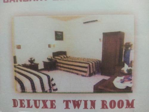 una habitación con 2 camas y un cartel que dice dividir la habitación con 2 camas individuales en Hotel Anging Mammiri, en Makassar