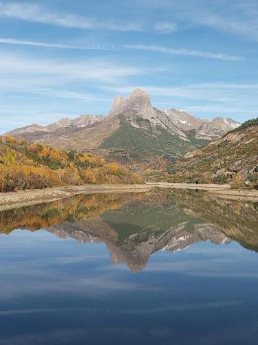 a reflection of a mountain in a body of water at Arriu Mage 105 in Bielle