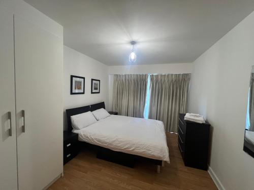 a small bedroom with a bed and a window at Modern 1 Bed Flat in Colindale, London in Colindale