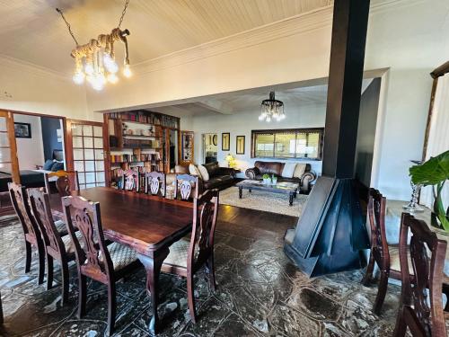 a dining room with a wooden table and chairs at 49onMain Self Catering Holiday Home in Sabie