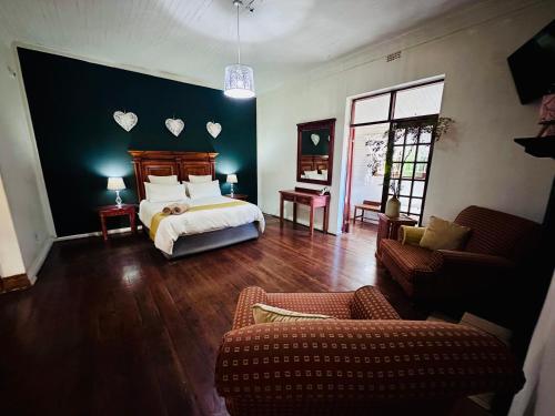 a bedroom with a bed with hearts on the wall at 49onMain Self Catering Holiday Home in Sabie