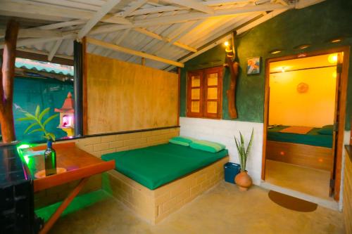 a room with a green bench in a house at Rosa Shashi Cabanas in Galle