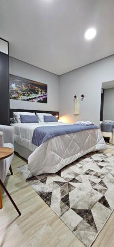 a bedroom with two beds and a rug at Apê Incrível! Perto de TUDO! in Porto Alegre