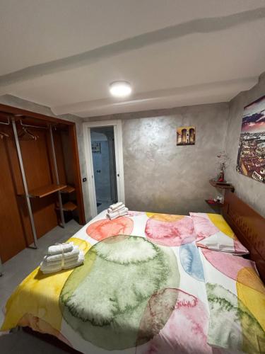 a bedroom with a large bed with a colorful blanket at Casa Sofia in Naples