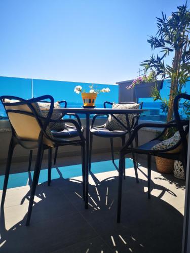 a table and chairs on a balcony with plants at Amici Miei Makarska in Makarska