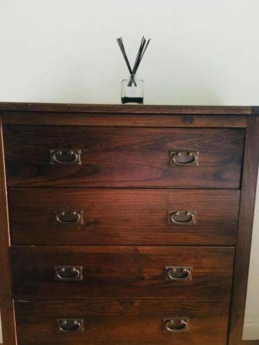 a wooden dresser with a plant on top of it at Modern and chic rooms with beautiful landscape views in Sydenham