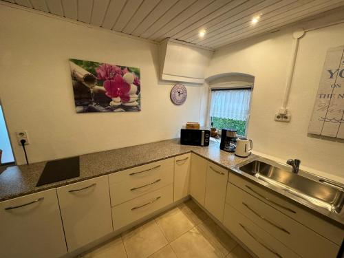 a kitchen with a sink and a counter top at FeWo beim Alex in Laufen