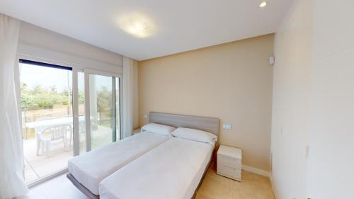 a bedroom with a bed and a large window at Edelweiss by ON Travel in Oliva