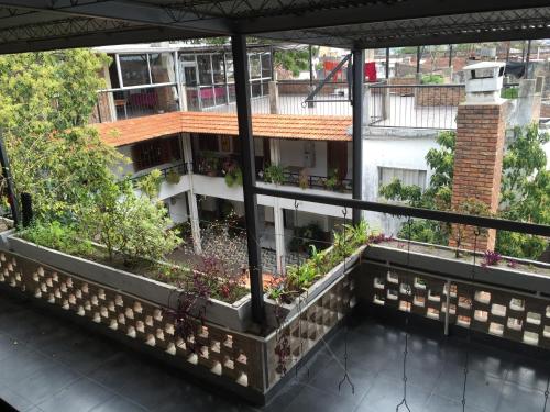 a balcony of a building with plants on it at Hotel Tia in Salto