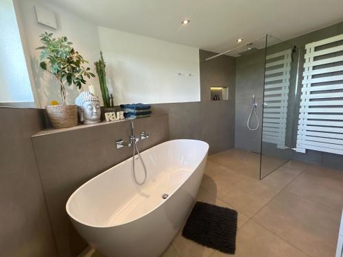 a large bathroom with a tub and a shower at Apartment Ihm in Memmingen