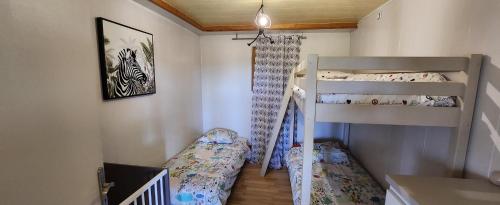 a bedroom with two bunk beds and a crib at Siber & Sandrine in La Seyne-sur-Mer