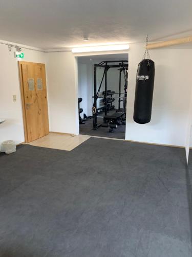 a gym with a punching bag hanging from the wall at Appartements Wolf in Leutasch