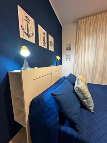 a blue bedroom with a bed and a night stand at BluMare ForFamily in Gallipoli