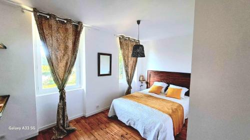 a bedroom with a bed and a window at Domaine de Cachaou Villa Leyr'ial sauna & spa in Salles