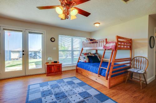 a bedroom with a bunk bed and a ceiling fan at Spacious Livingston Home with Private Boat Dock in Livingston