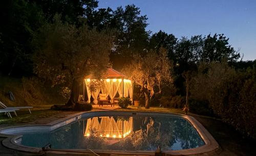 einen Pavillon in der Nacht mit Pool in der Unterkunft Il Fienile in Tavarnuzze
